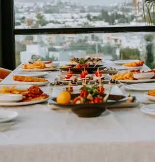 Mat servert på et bord på en restaurant med utsikt over byen