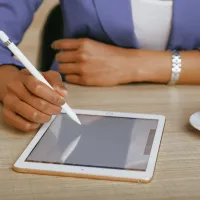 iPad på bordet hvor det legges en ipen på.