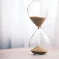 Timeglass stående på et trebord som renner sakte